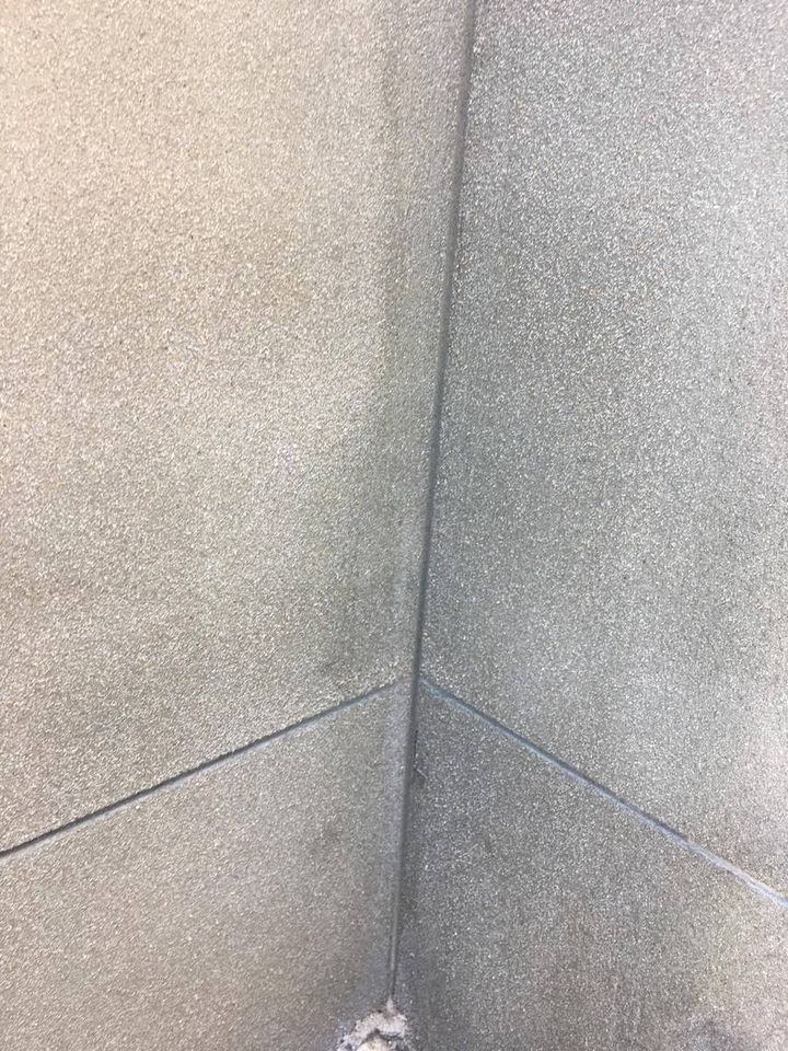 A rendered external corner with a control joint cut cleanly down its length