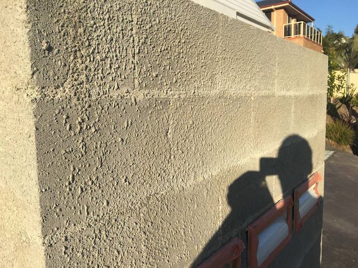 Close view of a completed sand finish wall showing its even, open grain