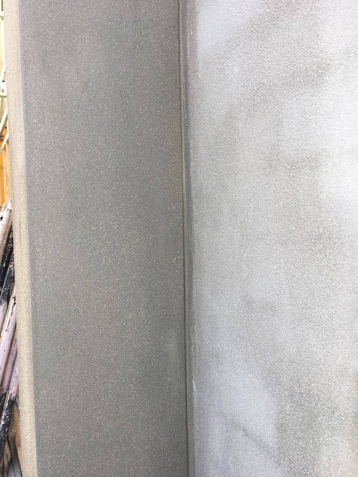 A smooth rendered external corner with an unbroken flat face on both sides